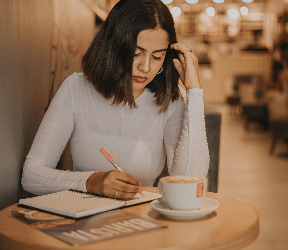 Lady writing down a career plan 